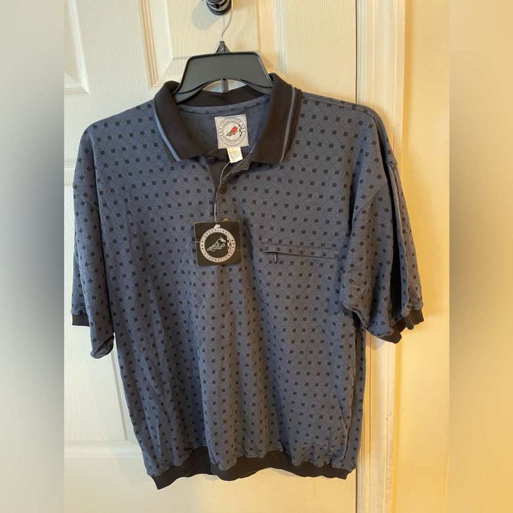 Dusty Blue Polo with black design. Collar is black with blue line. NEW WITH TAGS